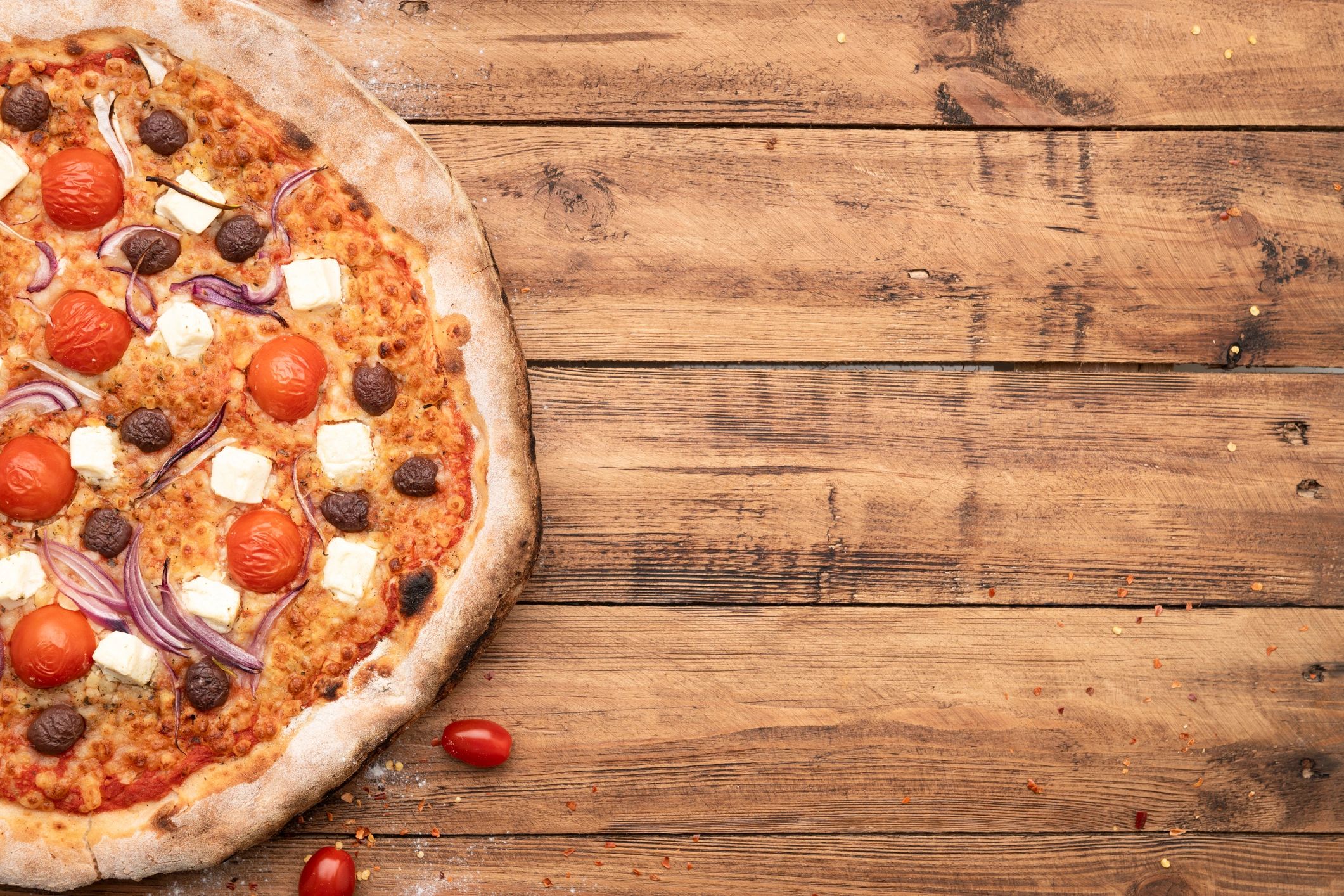 Wood-fired pizza served on a restaurant table